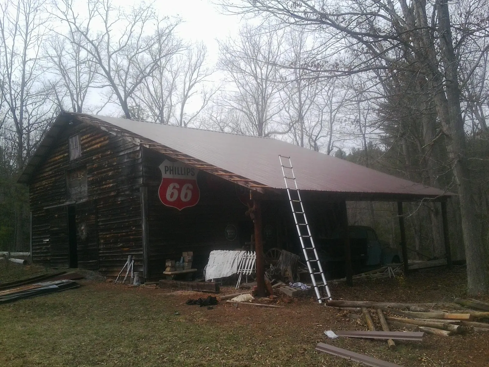 New metal roof on an open sided timber barn with a vintage sign in Lincolndale